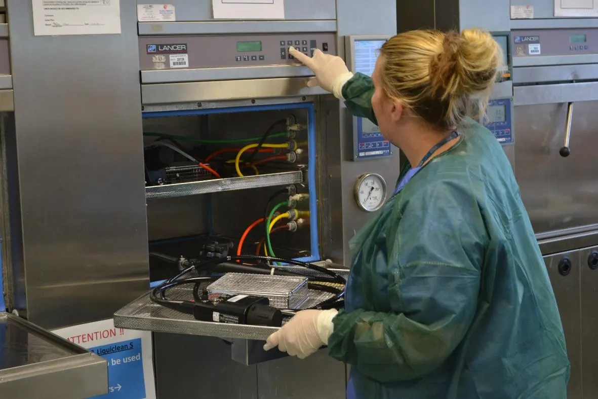 Sterile services technician loading a sterilisation machine